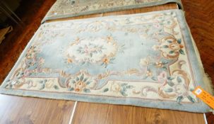 Chinese wool rug on pale blue ground, floral and scroll decoration,