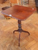 A 19th century rectangular tilt-top tripod table on turned baluster column,