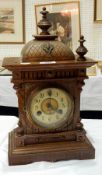 An eight-day movement clock with finials,