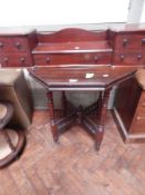 A stained wood hexagonal occasional table on block supports united by cross-stretcher,