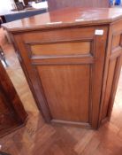 A mahogany corner cupboard, the panel door enclosing three shelves,