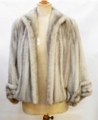 A grey mink jacket/cape labelled 