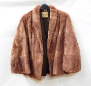A vintage mink stole with tail fringe, a vintage dark squirrel stole,