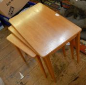Nest of three teak side tables on tapering legs,