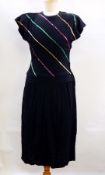 A black crepe cocktail dress by Peggy Goss of Birmingham, trimmed with black velvet,