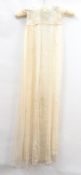 A silk and net cream-coloured christening gown,