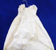 A cotton full-length baby gown with ruched bodice,