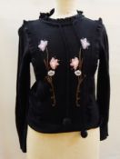 A vintage knitted jumper with embroidered flowers and a frill, a 1950's blouse,