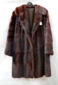 A vintage musquash coat together with a vintage fur coat labelled 