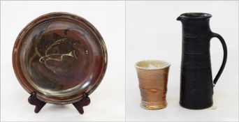 Studio pottery dish having incised line frieze and central stylised bird with mottled brown
