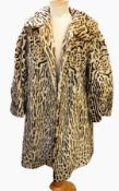 A faux-fur coat printed leopard skin pattern and a white faux-fur jacket labelled 