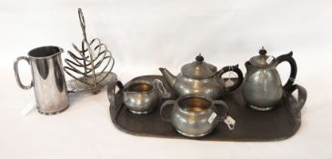 Tudric hammered pewter tea service for Libertys, comprising teapot, hot water jug, sugar bowl,