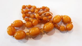 Yellow amber-type graduated bead necklace interspersed with yellow glass beads