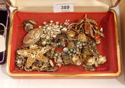 Assorted costume jewellery, including brooches, a pendant, a butterfly wing,