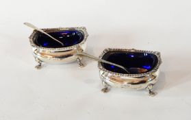 A pair of George V silver open salts with gadrooned borders, raised on cabriole legs with paw feet,
