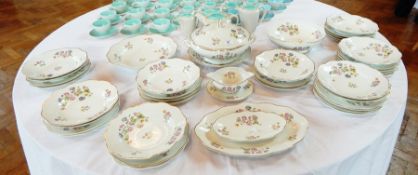 A Limoges part dinner service comprising dinner plates, bowls, serving dishes, a covered tureen,