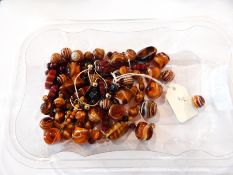 Jade pendant, shaped oval and floral design with gold-coloured metal leaf suspension,