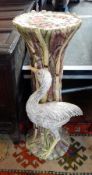 A decorative ceramic jardiniere stand with floral and bird decoration,