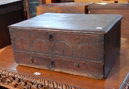 An 18th century carved oak bible box with moulded edge top and arcaded carving to front with long
