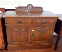 An early Victorian oak sideboard with art nouveau style carving,