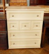 A modern chest of four drawers with ball handles,