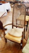 A cane back open armchair