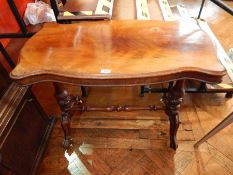 A mahogany scalloped edged side table on cabriole legs united by turned stretchers,