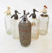 Five vintage soda syphons, one labeled 