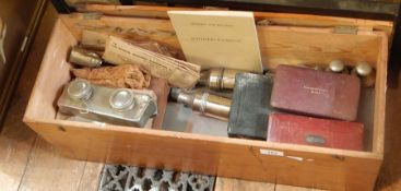 A surgical set with bone-handled scalpels and other instruments, in fitted red leather case,