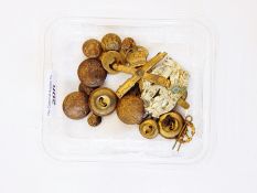 A collection of buttons and cap badges including The Royal Artillery Badge,