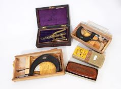 Three micrometers in varying sizes and architects instruments