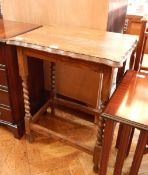 An oak occasional table with serpentine border, on square and spirally turned supports,