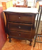 A small cabinet with three long and two short drawers,