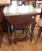 An oak gateleg table with spirally turned supports,