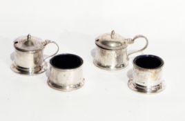 A mid 20th century silver mustard pot and cover together with another and a pair of cylindrical
