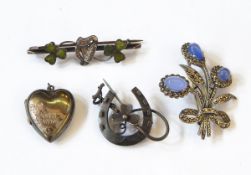 A silver floral spray brooch, the blue cabochon set in a marcasite surround,