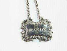 A Georgian Scottish silver decanter brandy branded label with scrollwork border and chain