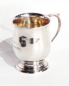 A George V silver christening mug of baluster form, raised on a circular foot, Birmingham 1925,