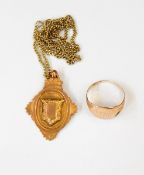 A 9ct gold fob pendant with vacant shield-shaped cartouche,