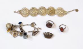 A silver charm bracelet, a brooch, a foreign silver bracelet,