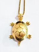 An 18ct gold turtle pendant with ruby eyes and moveable joints,