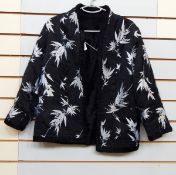 Black Chinese style jacket with white embroidery, black lace shrug, cream evening gown,