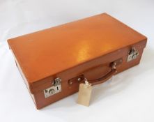 A brown leather packing case with leather strap