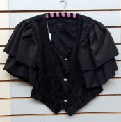 A black satin evening dress, strapless, fitted, with large bow detail to the back,