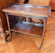 An oak folding top tea trolley with undershelf,