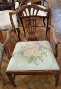 A Georgian mahogany open armchair with hump shaped crest rail and pierced splat grospoint woolwork