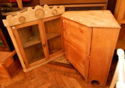 A glazed pine corner cupboard with pair panelled doors enclosing shelf together with another pine