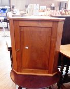 A small walnut corner cupboard, the fielded panel door enclosing shelf,