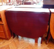 A contemporary drop-flap dining table on square supports,