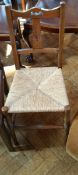 A stained beech rush seated Arts & Crafts style standard chair with pieced heart-shaped splat